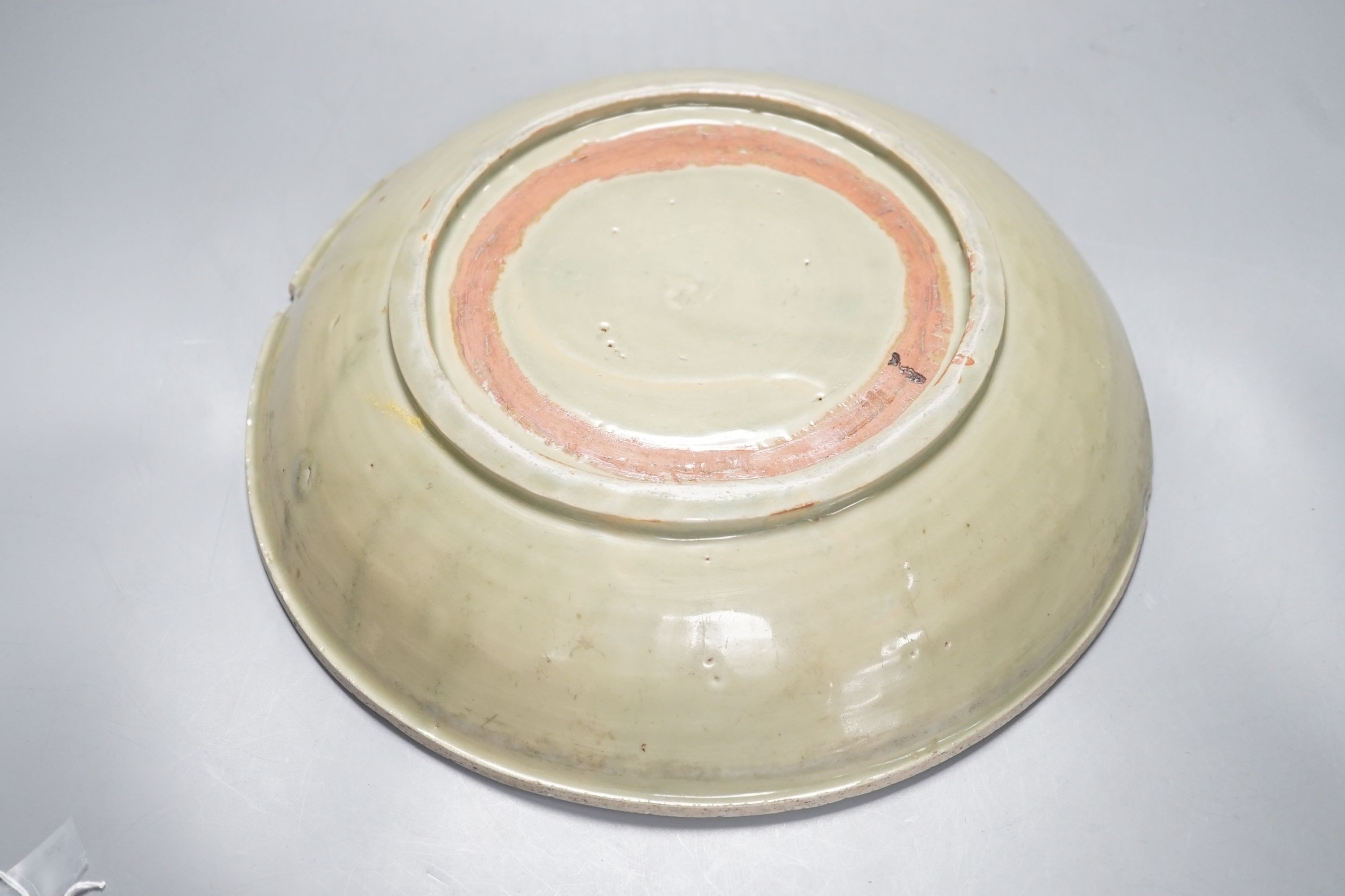 A Chinese Ming Longquan celadon dish, 15th/16th century, rim cut down, width 33cm